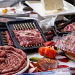 A variety of meats and vegetables arranged for an outdoor barbecue in Switzerland.